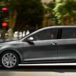 a group of friends riding through the city in a 2019 volkswagen golf