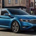 The 2019 VW Jetta driving down a city street.