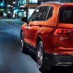 Orange 2018 Volkswagen Tiguan navigating through city streets