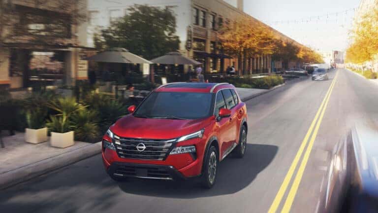 2024 Nissan Rogue Exterior Driving In Town With Motion Blur