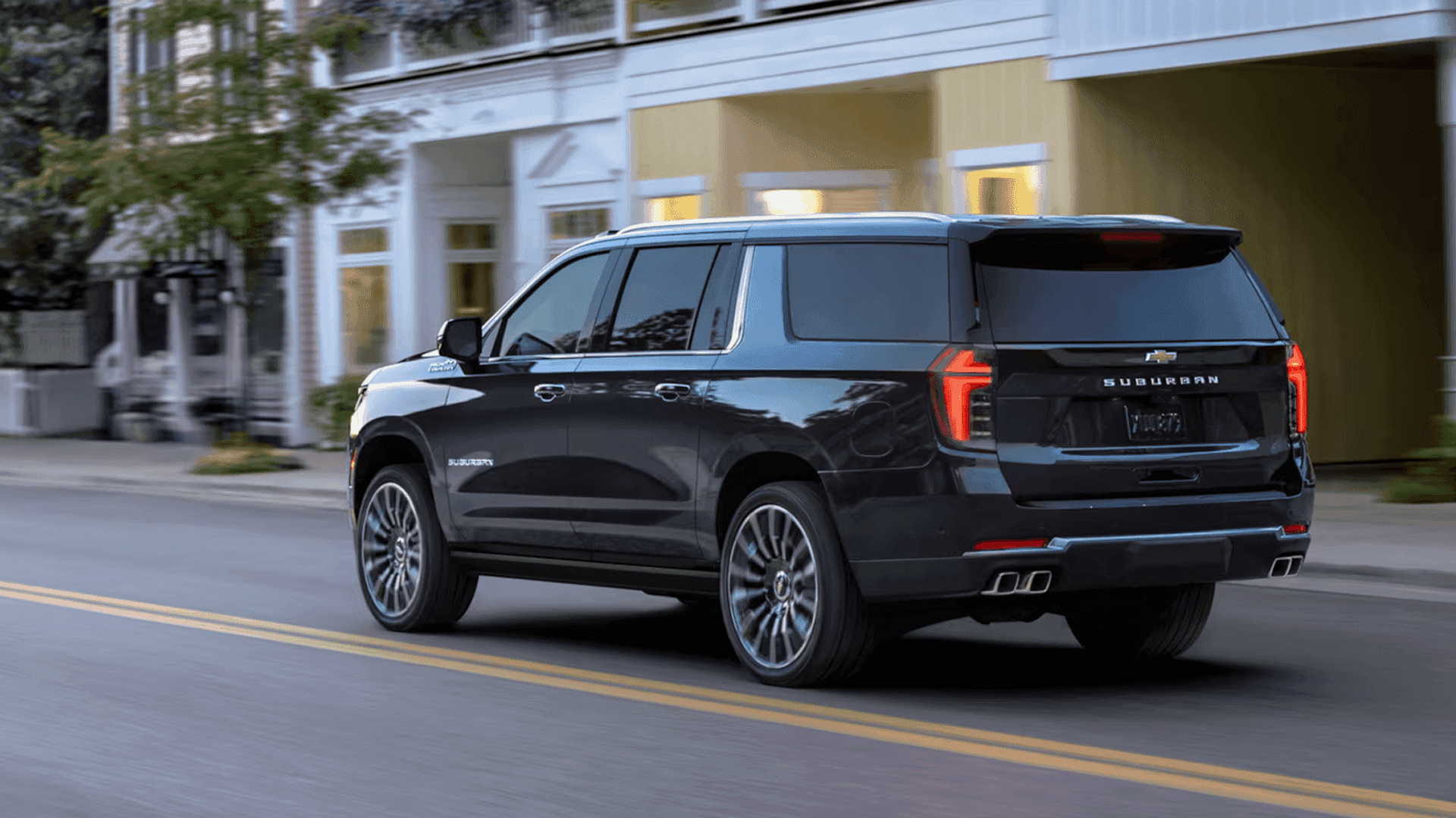 2026 black suburban driving down a city street