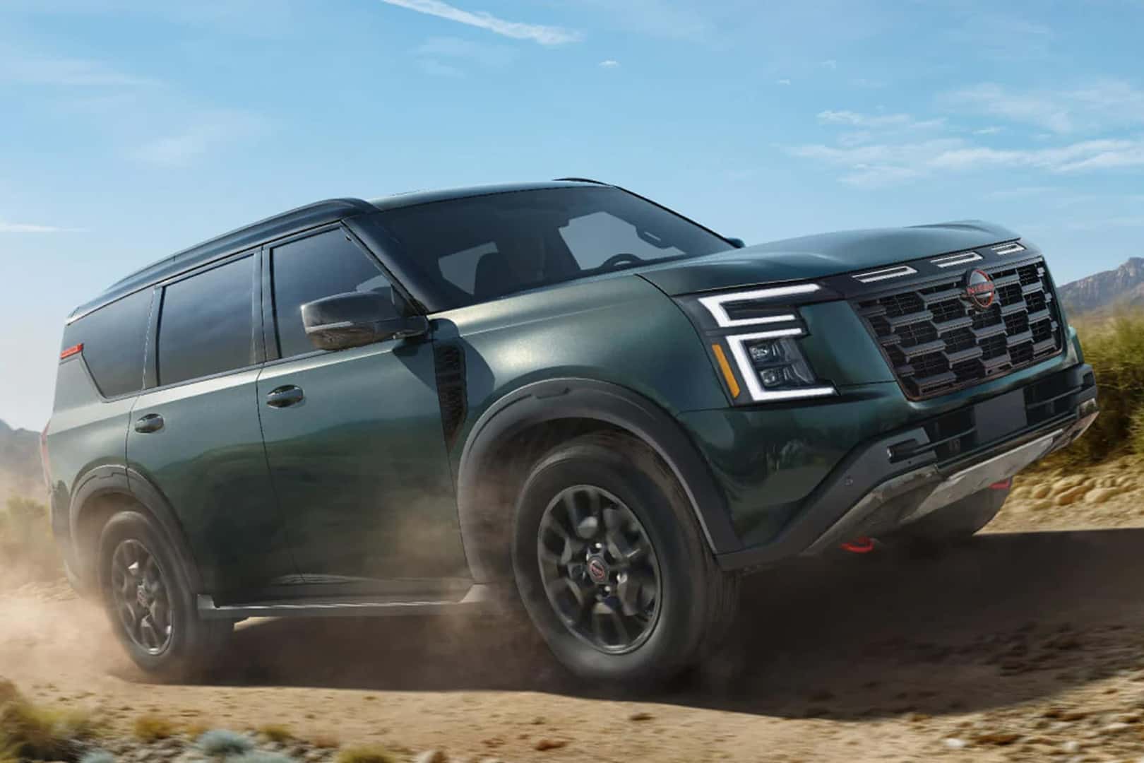 26 nissan armada driving down a dirt road