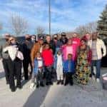 group of people posing for photo in parking lot