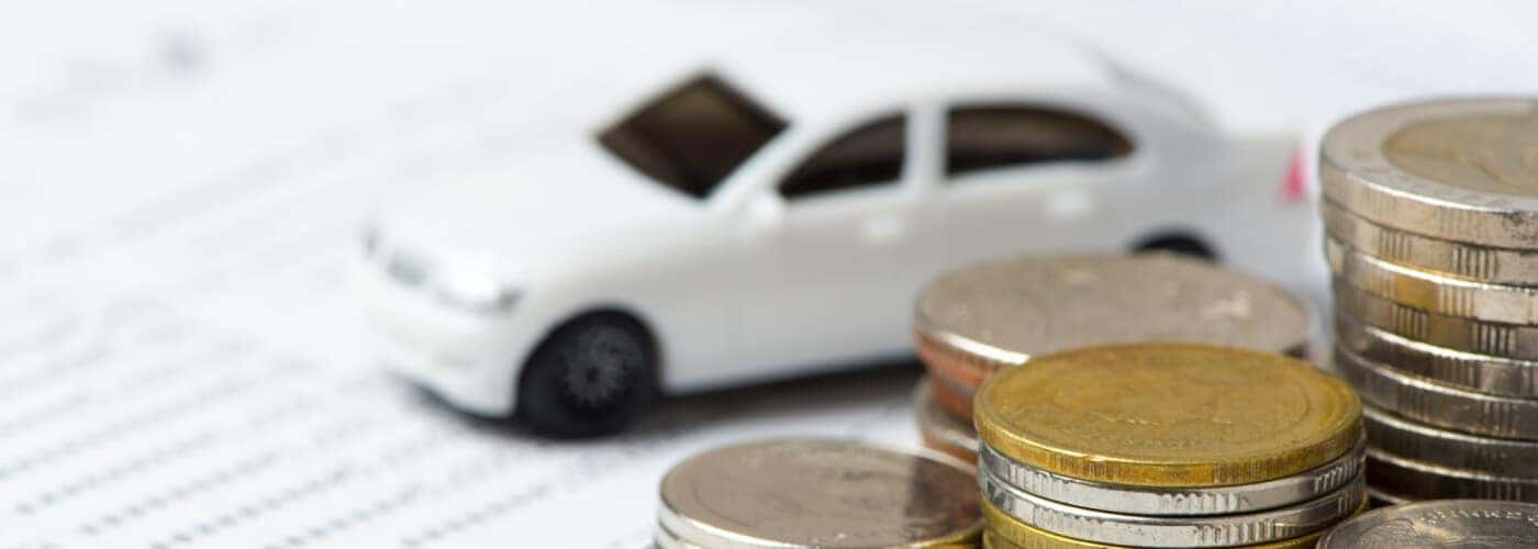 car finance paperwork with tiny white car
