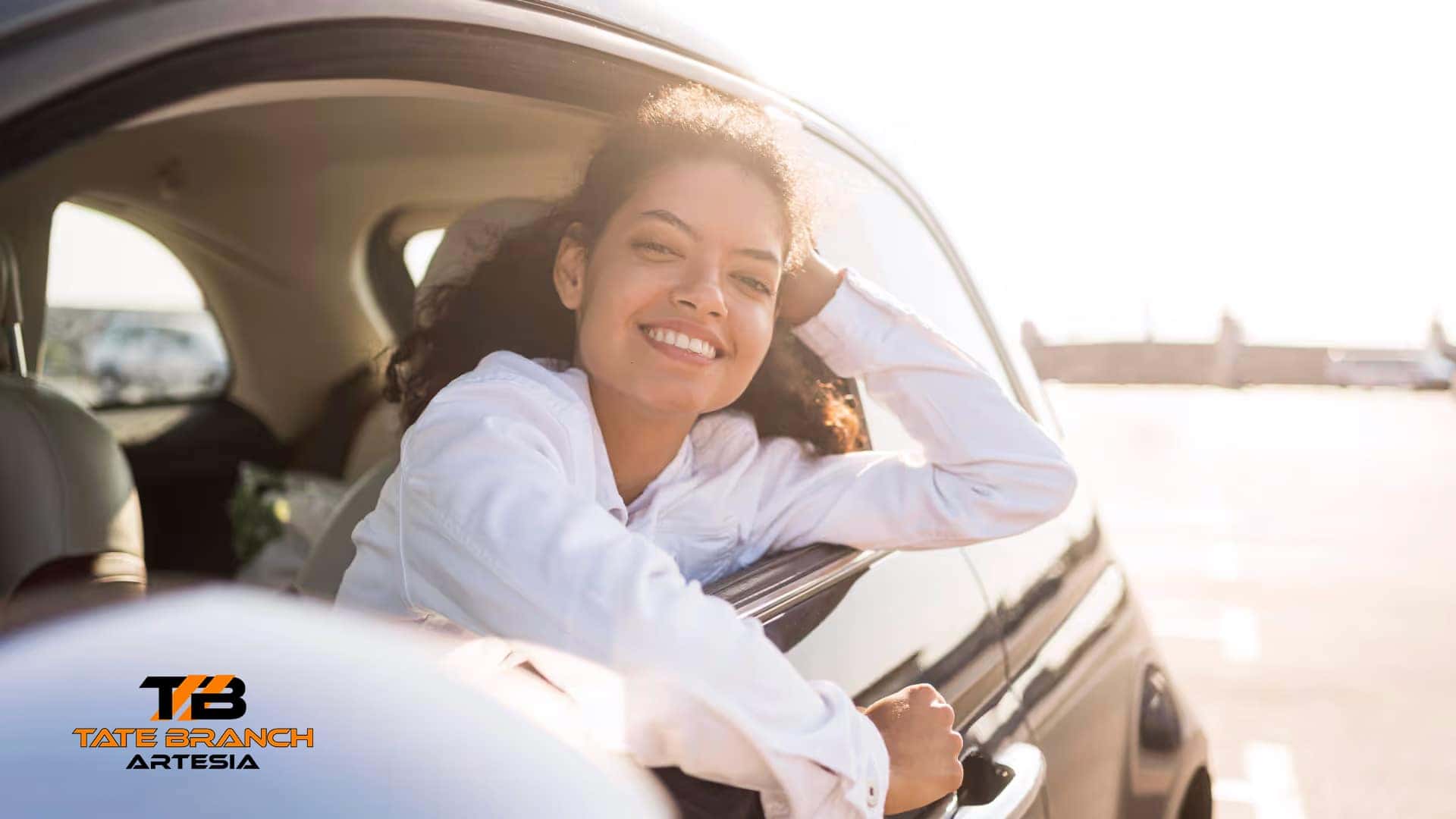 pretty woman smiling inside car graphic