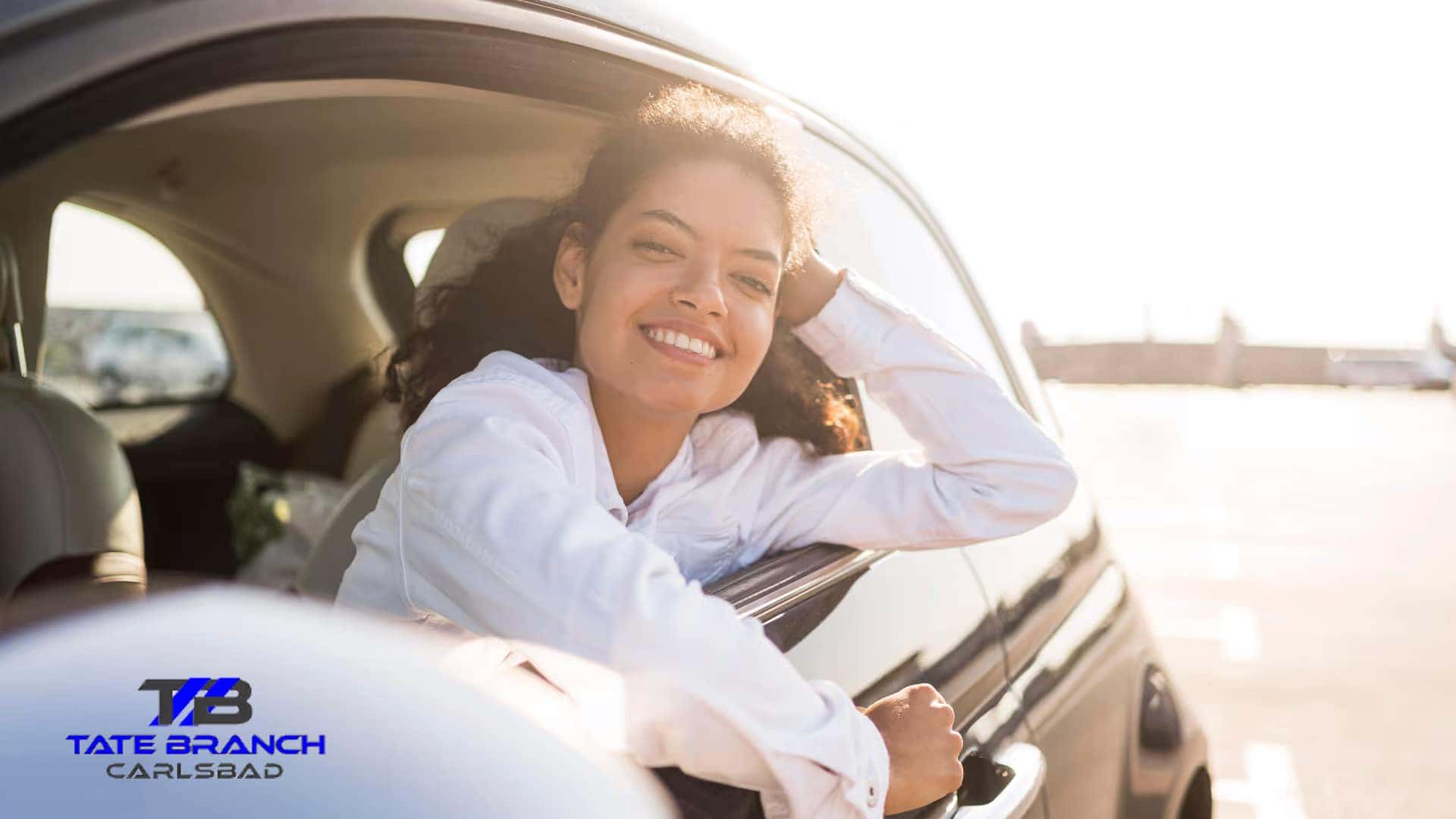 pretty woman smiling inside car graphic