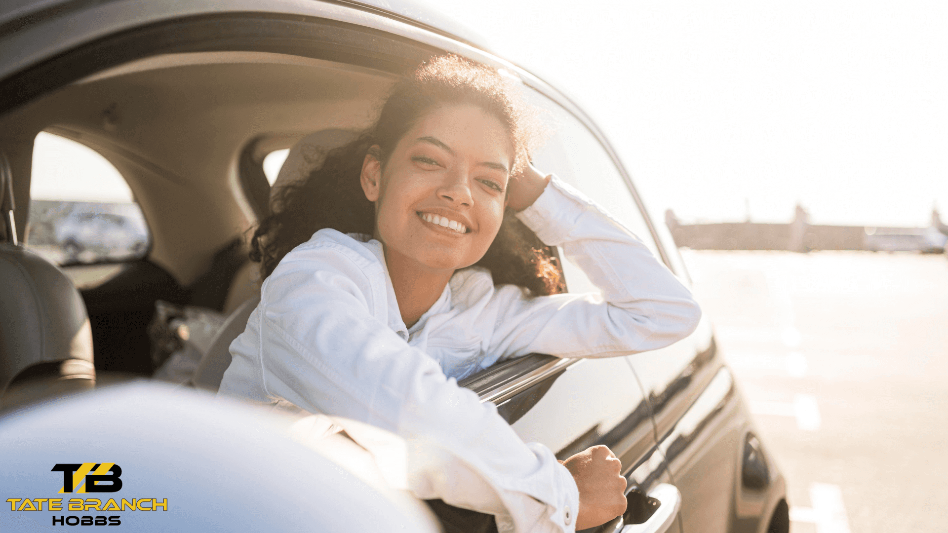 pretty woman smiling inside car graphic