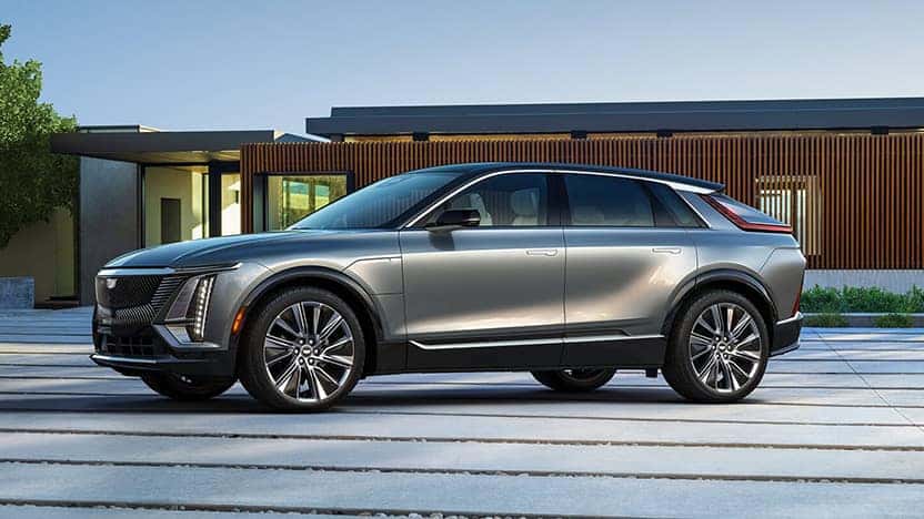 2023 Cadillac LYRIQ in silver in front of a house.