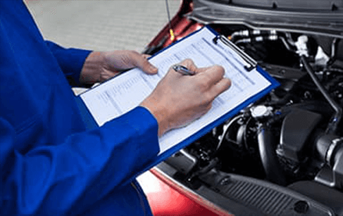 Service technician inspecting engine