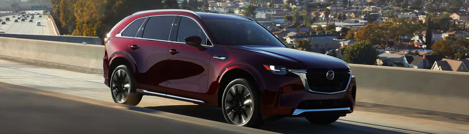 2024 Mazda CX-90 driving on a freeway.