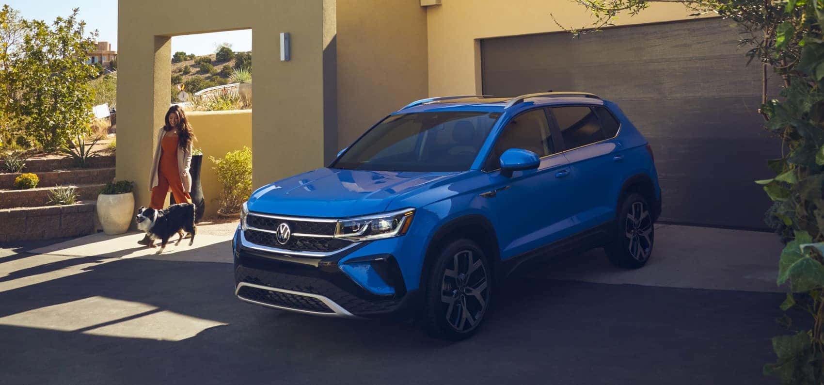 2022 Volkswagen Taos 4MOTION cornflower parked in driveway