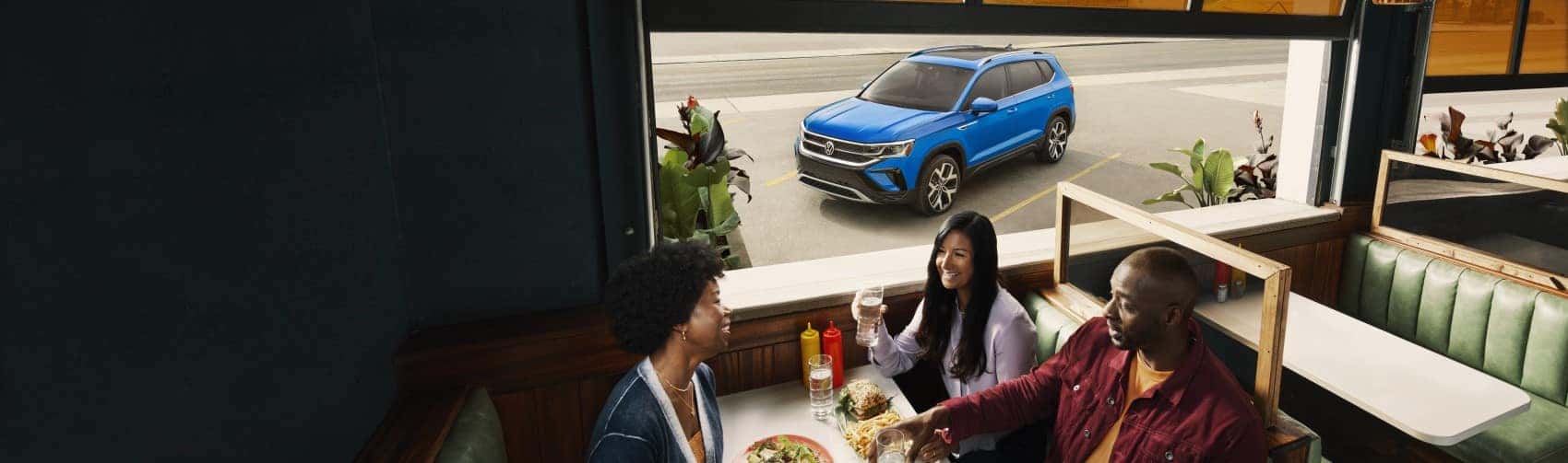 2022 Volkswagen Taos Cornflower parked outside of restaurant