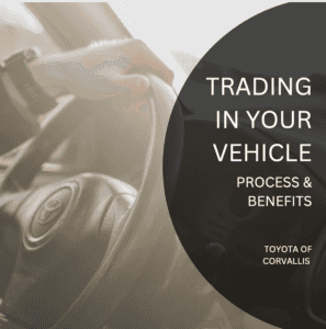 "Trading in your vehicle process and benefits Toyota of Corvallis" over a photograph of a toyota steering wheel with a hand on them.