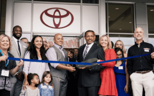 photograph of the Jackson family and the toyota of Corvallis employees doing the ribbon cutting for the new Toyota of Corvallis building