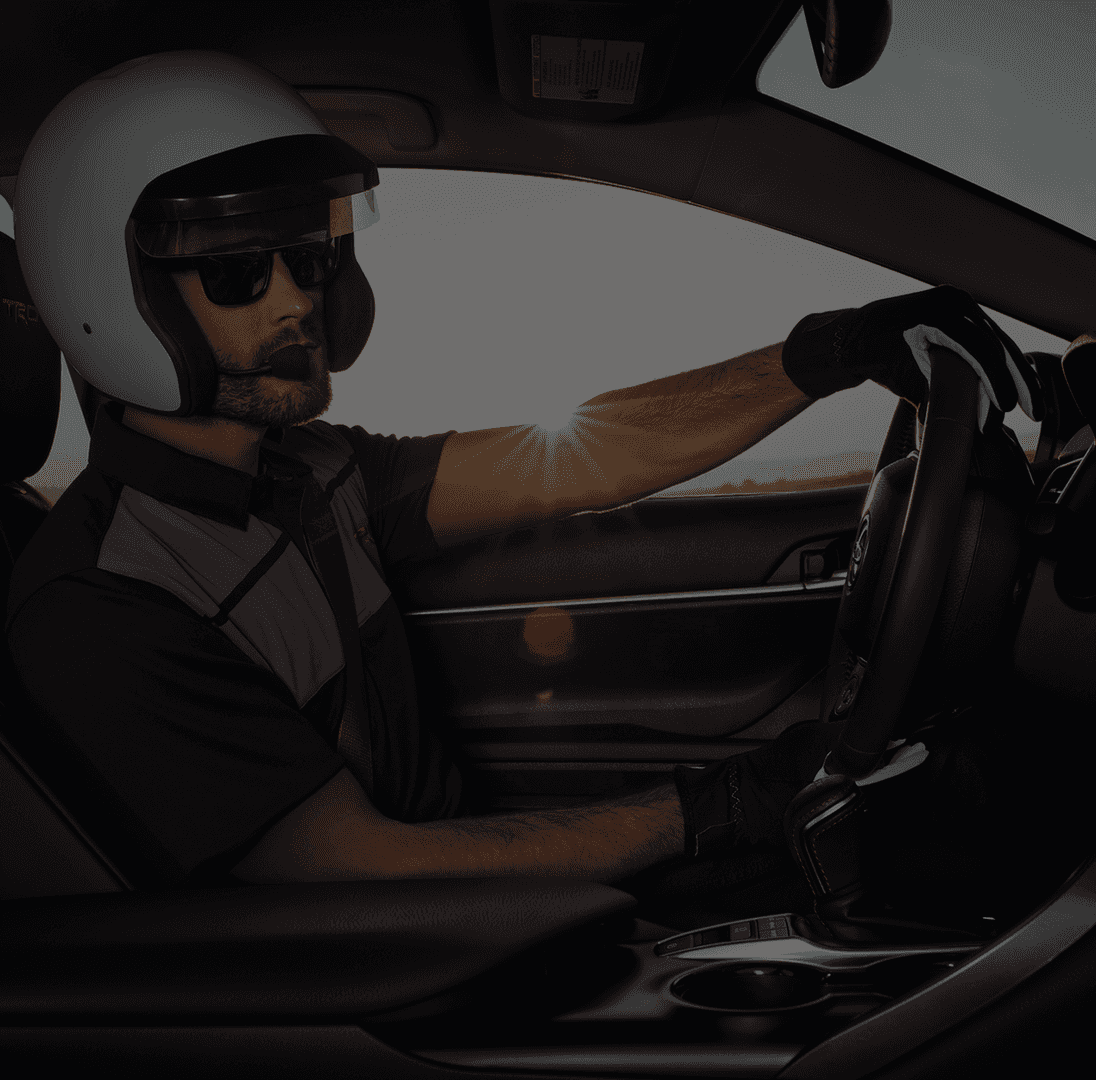 man with helmet driving car
