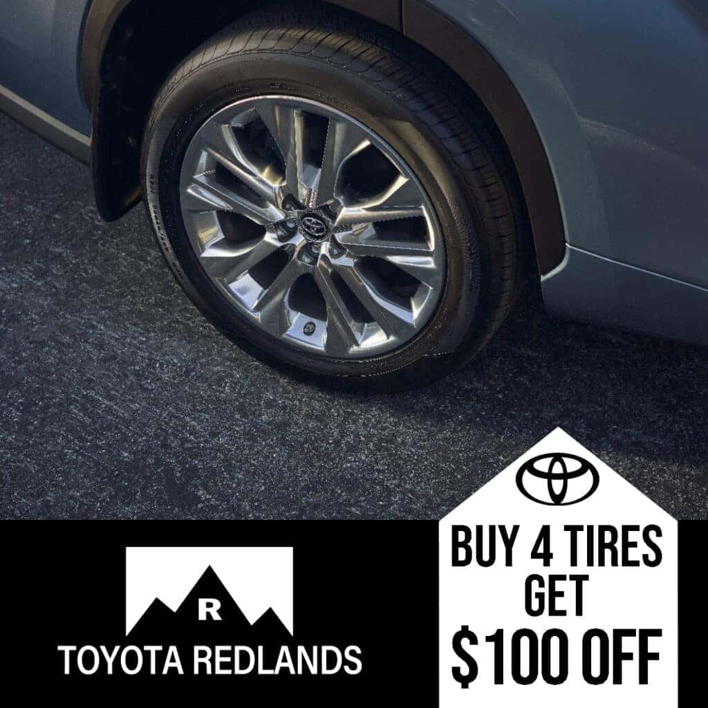 Photo showing a tire with text saying "buy 4 tires get $100 off."