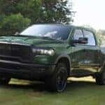 Green 2026 RAM 1500 towing a trailer