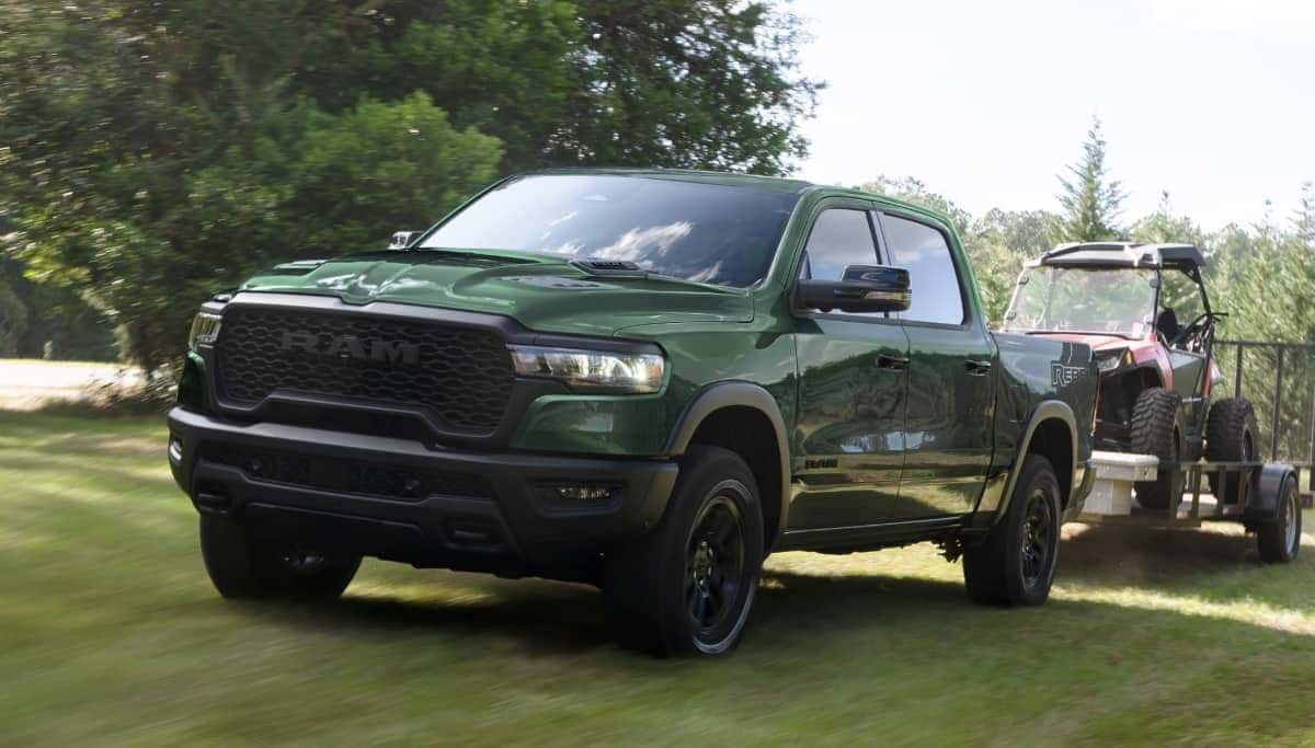 Green 2026 RAM 1500 towing a trailer
