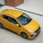 side view of yellow mitsubishi compact car