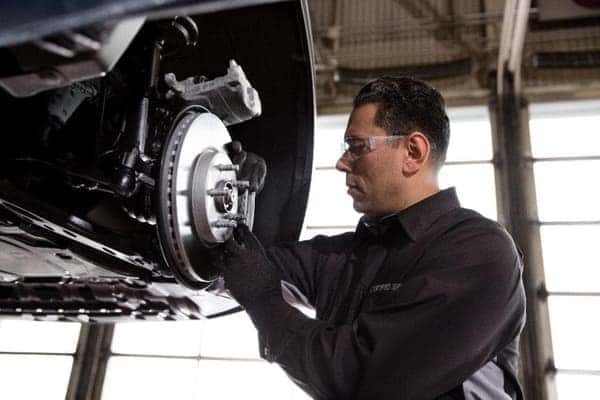 person fixing car