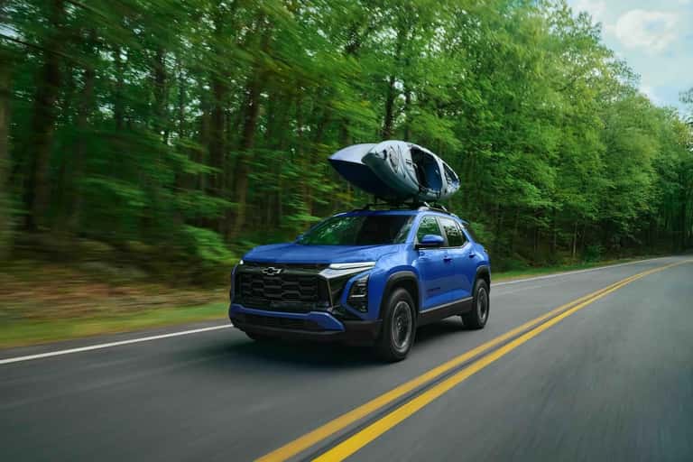 2027 Chevrolet Equinox driving exterior shot with canoe