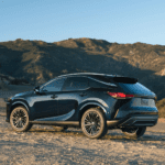 The 2026 Lexus RX driving through a field